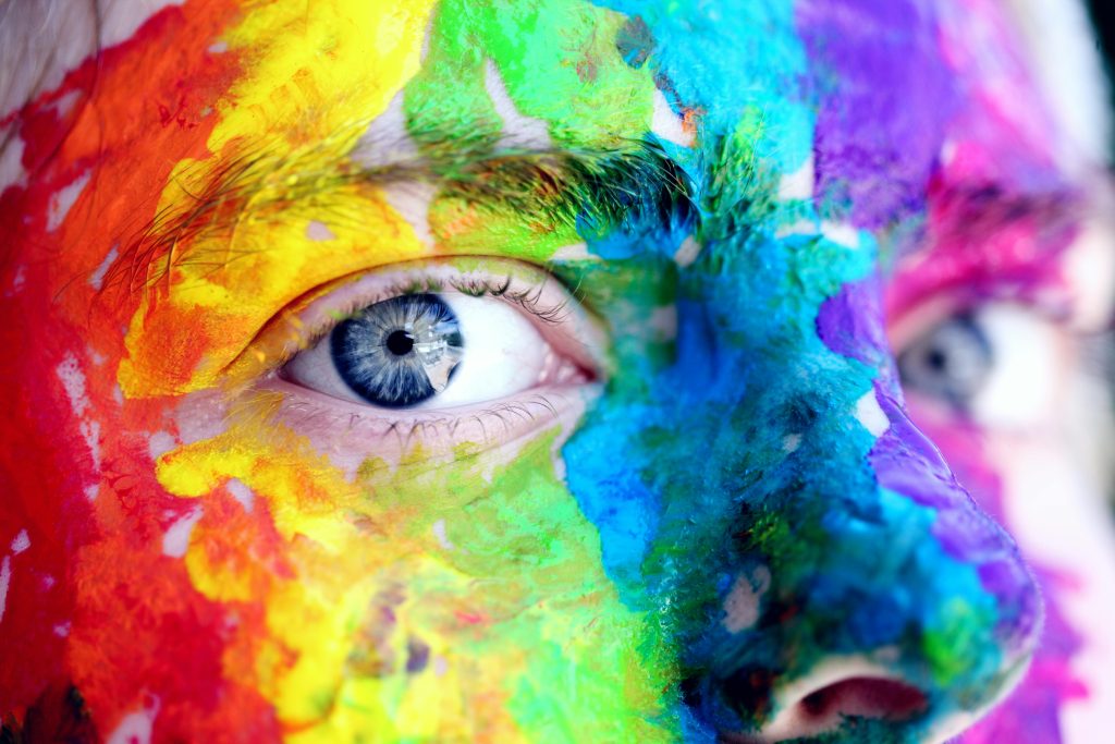 pexels photo 1209843 1209843 Close-up of a person with colorful rainbow face paint, symbolizing LGBT pride and expression.